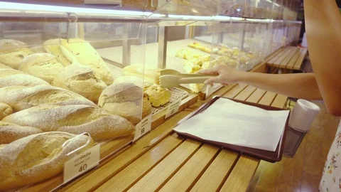 Woman selecting breads in bakery Stock Footage 79046311
