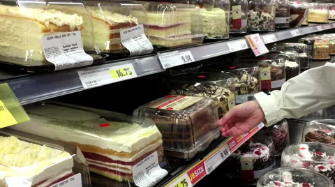Woman selecting cake inside superstore Stock Footage 58565313
