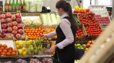 Woman selecting fruit at market and adds to cart, rear view Stock Footage 59338365