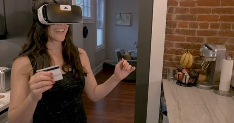 Woman selecting items in a virtual reality store wearing VR googles Stock Footage 82272640