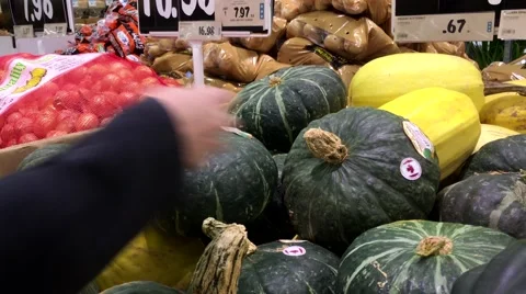 Woman selecting Japanese pumpkin in grocery store produce department Stock Footage 59747556