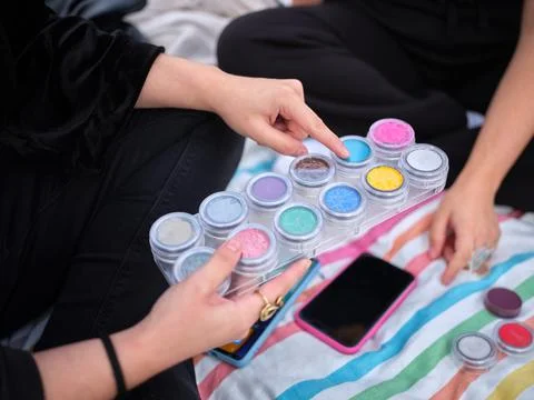 Woman selecting the paint sample with which she is going to characterize Stock Photos