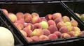 Woman Selecting Peaches In Produce HD Footage