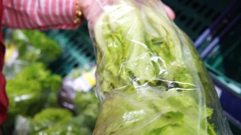 Woman selecting vegetable in organic section of supermarket Stock Footage 98651732