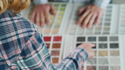 Woman selects color samples from material palette with hands, creating dyna.. Stock Footage 334768247