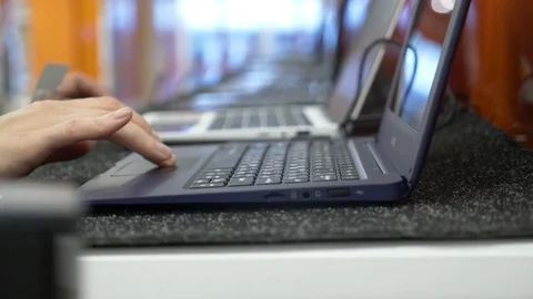 Woman selects a laptop in an electronics store. 4k, slow motion Stock Footage 82909455
