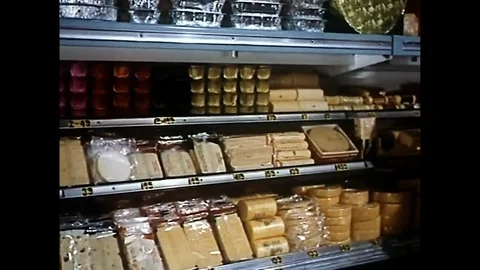 Woman Selects Packaged Cheese From Refigerated Case In Supermarket Stock Footage 94359273
