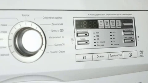 Woman selects program of wash of washing machine Stock Footage 69148258