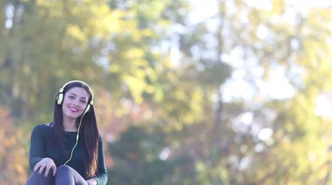 Woman sending kiss to camera while listening to music with headphones Stock Footage 59555306