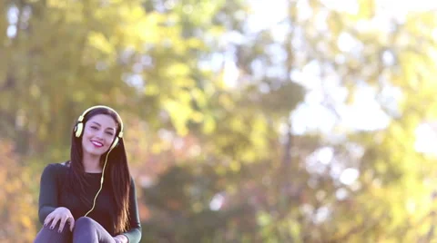 Woman sending kiss to camera while listening to music with headphones Stock Footage 59555307
