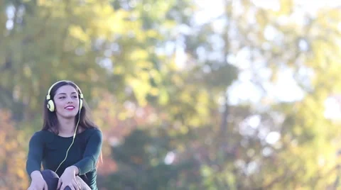 Woman sending kiss to camera while listening to music with headphones Stock Footage 59555313