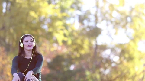 Woman sending kiss to camera while listening to music with headphones Stock Footage 59555315