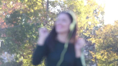 Woman sending kiss to camera while listening to music with headphones Stock Footage 59555317