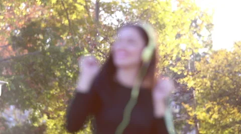 Woman sending kiss to camera while listening to music with headphones Stock Footage 59555318