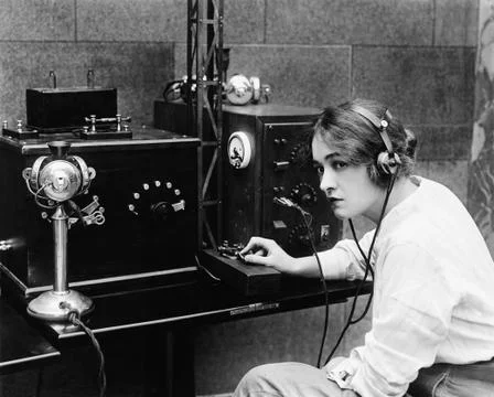 Woman sending Morse code using telegraph Stock Photos