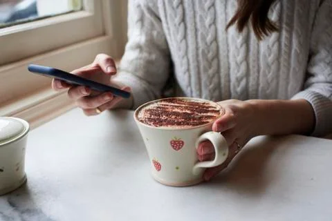 Woman Sending Text Message And Drinking Cappuccino Stock Photos