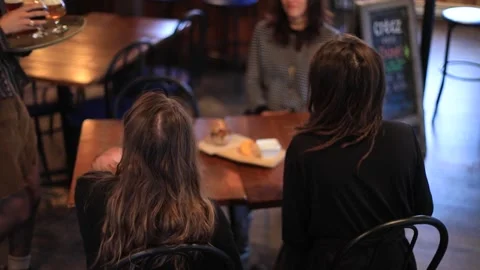 Woman serving beer to customer Stock Footage 130210906