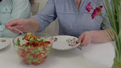 Woman serving fresh salad on a plate Stock Footage 321041753