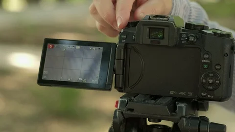 Woman set self timer on tripod mounted camera then takes a selfie Stock Footage 116962300