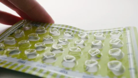 Woman Sets Down an Empty Package of Birth Control Pills Stock Footage 112522695