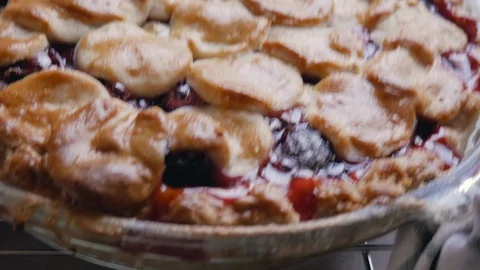 Woman Sets Down a Fresh Baked Cherry Pie to Cool Stock Footage 112016248