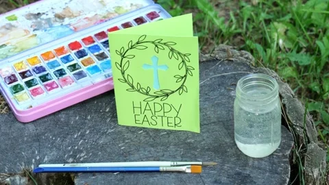 Woman Sets Down Handmade Happy Easter Card with Religious Christian Cross 4K Video stock 320222663