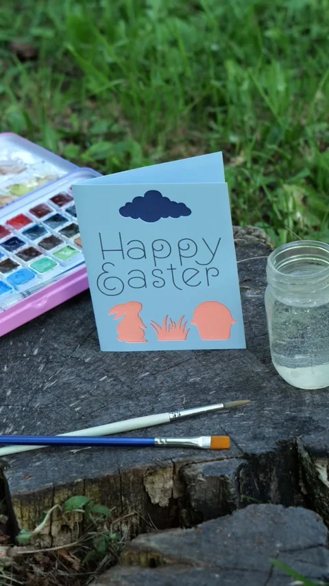 Woman Sets Down Handmade Happy Easter Card with Bunny Rabbit and Egg Basket 4K Stock Footage 320222743