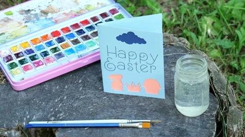 Woman Sets Down Handmade Happy Easter Card with Bunny Rabbit 4K Video Stock Stock Footage 320222748