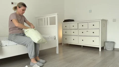 Woman Setting Cozy Bed In Bright Nursery. Caucasian Woman Tidies Nursery With Stock Footage 336469147