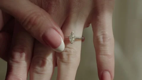Woman Setting Sparkling Ring Gently, Caucasian Woman Carefully Handling Stock Footage 323770662
