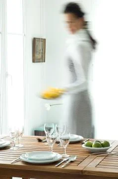 Woman setting the table Stock Photos