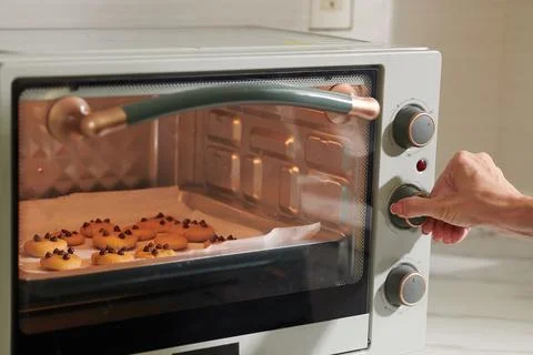 Woman Setting Timer on Oven Stock Photos