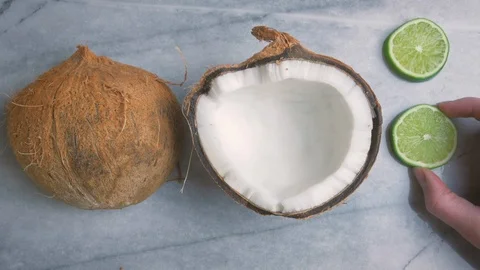 Woman Setting Up A Top Down Flat Lay with Coconuts and Limes in 4k Stock Footage 90071111