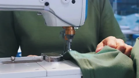 A woman sewing clothes using sewing machine Stock Footage 138655936