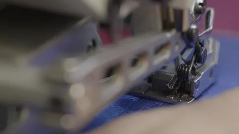 Woman sewing on a sewing machine overlock Stock Footage 276830791