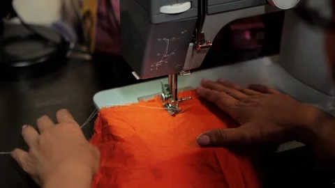 Woman sewing using sewing machine and manual on the table Stock Footage 172400099