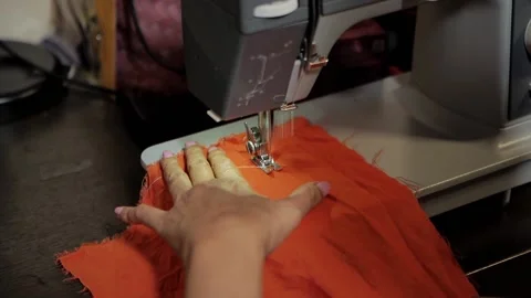 Woman sewing using sewing machine and manual on the table Stock Footage 172400163