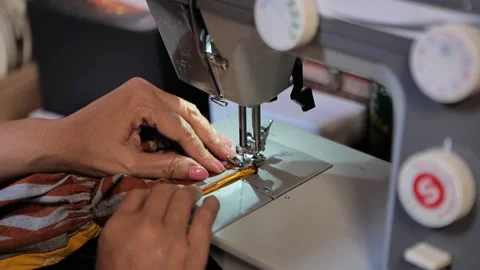 Woman sewing using sewing machine and manual on the table Video stock 172405670