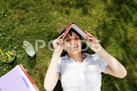 Woman Shielding Face With Book