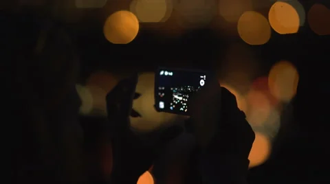 Woman Shooting water lanterns using a mobile phone Stock Footage