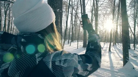 Woman is shooting the winter woods.  Uses navigation on the phone Stock Footage