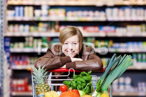 Woman with a shopping cart of fresh produce Stock Photos