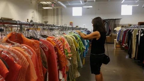A woman shopping for clothes at a retail store Stock Footage