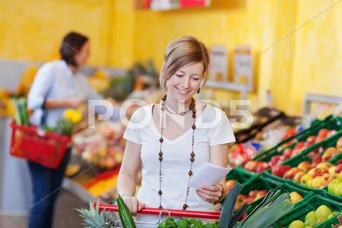 Woman with a shopping list in a supermarket Stock Photos