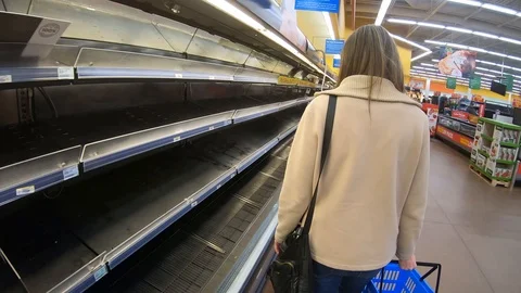 A woman shops an empty supermarket during the coronavirus COVID-19 Stock Footage