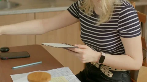 A woman showcases productivity at a table using various devices Stock-Footage 311370123