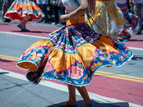 Woman showing dance moves wearing a Mexican fiesta dress Stock Photos