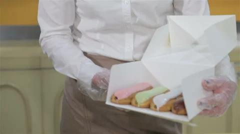 Woman shows the box with brewing cakes Stock Footage