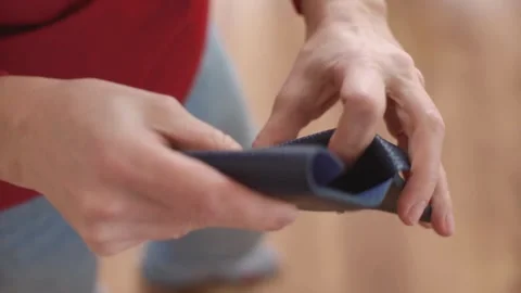 Woman shows her empty purses. Bankruptcy empty wallet clutches. The concept of Stock Footage 336450465