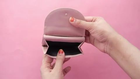 Woman shows her empty purses. Bankruptcy empty wallet clutches. The concept of Stock Footage 336450492